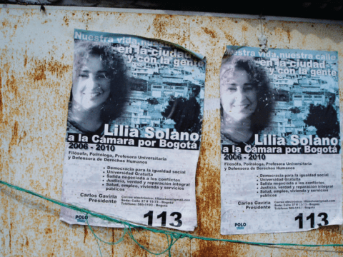 Photograph of tattered posters on wall