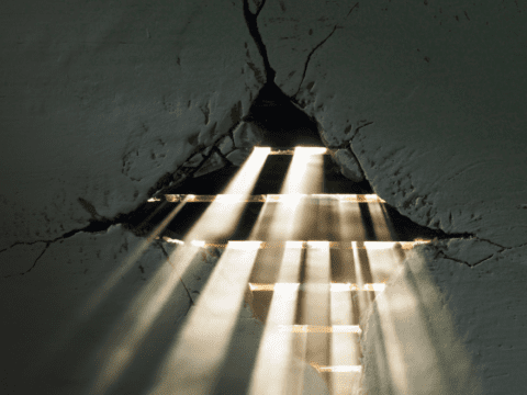 Light coming through hole in plaster wall
