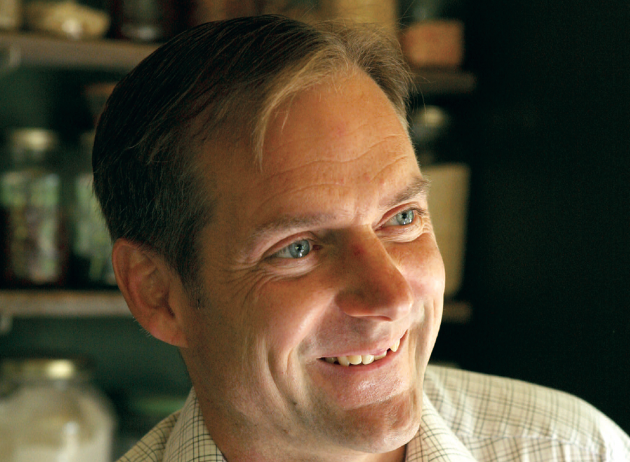 White man in button-up shirt with blue eyes
