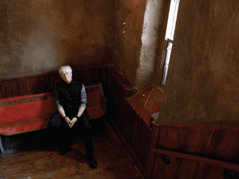 White-haired white man in church entrance, from above