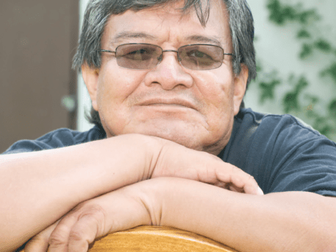 Indigenous man in sunglasses looking at camera