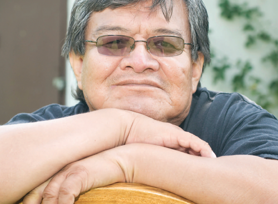Indigenous man in sunglasses looking at camera