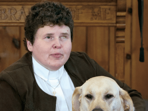 Blind white woman with dark hair and white dog