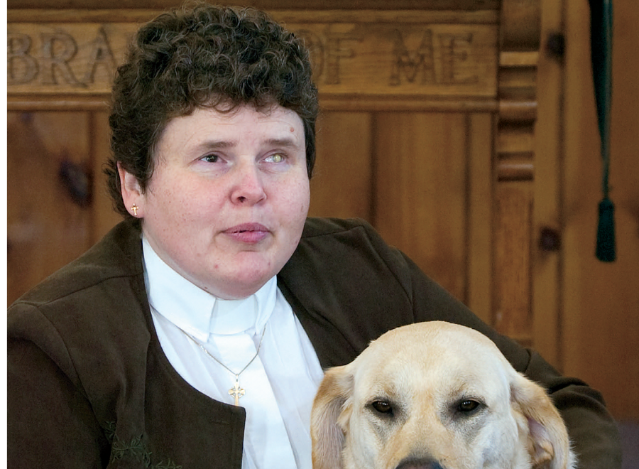 Blind white woman with dark hair and white dog