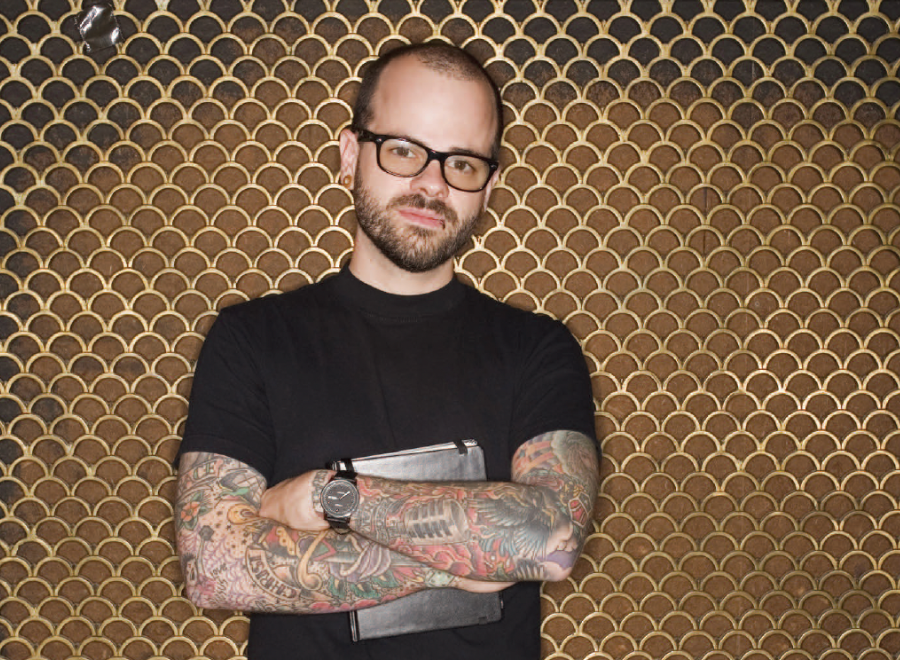 Young white man with tattoos wearing black T-shirt