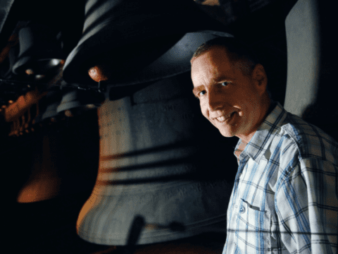 Young white man in front of carillon bells