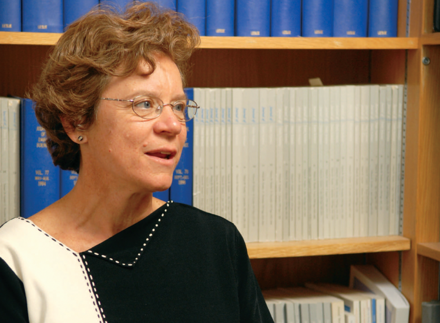 Red-haired woman with glasses in black an white dress