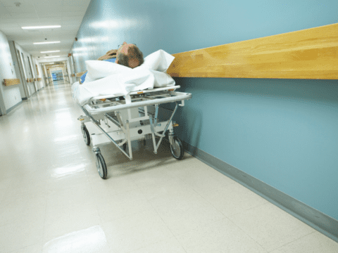 man on a gurney in a hospital hallway