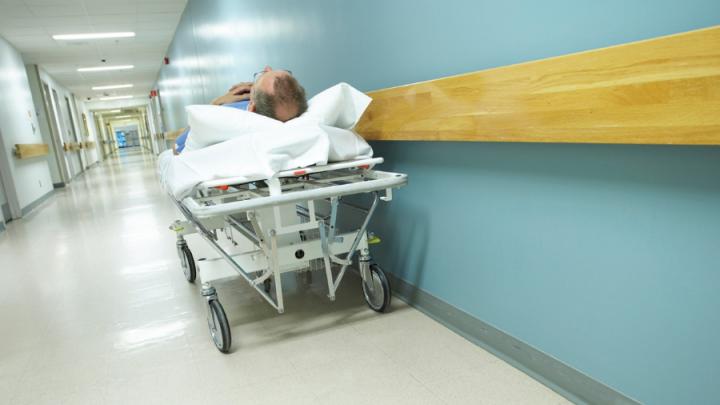 man on a gurney in a hospital hallway