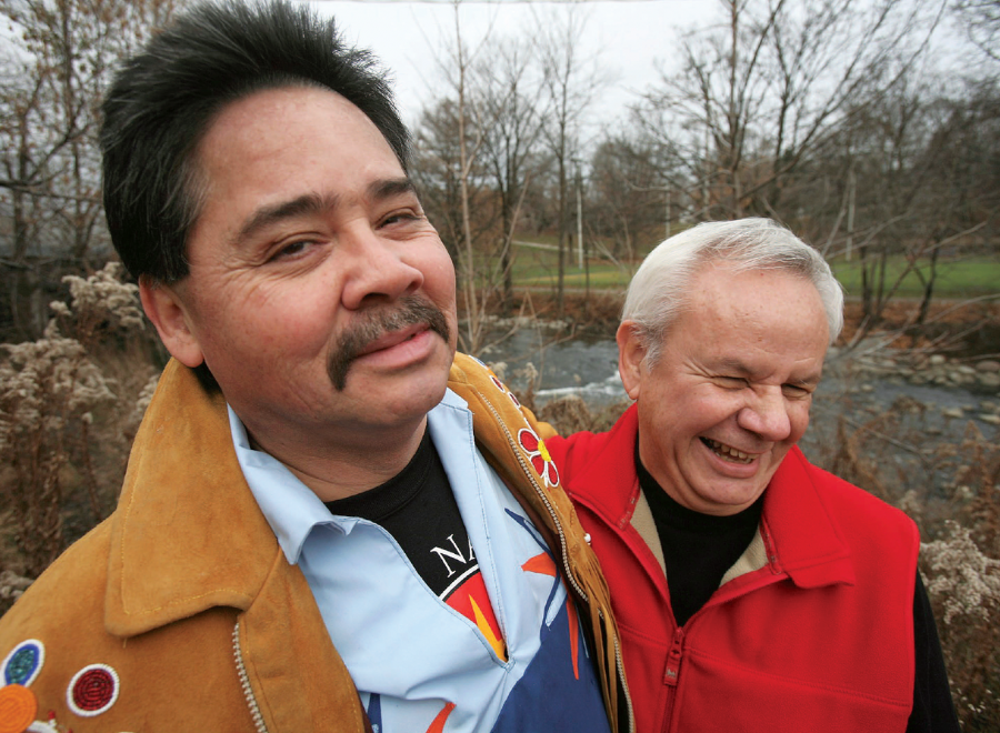 Two men smiling in winter forest