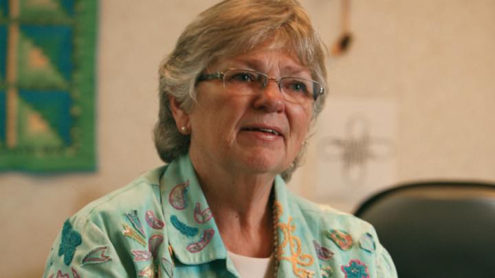 Older white woman in colourful shirt