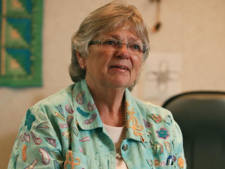 Older white woman in colourful shirt