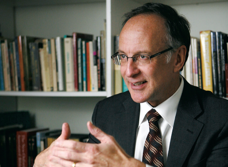 Balding white man in glasses, suit and tie