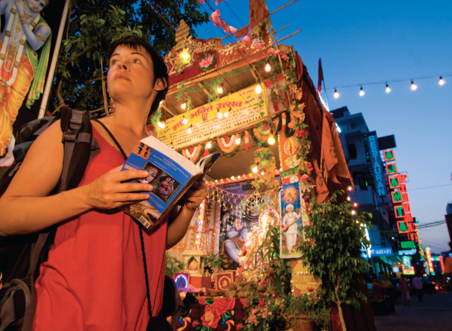 Young white woman with tour book in India