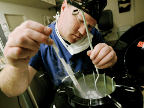 White man in surgical outfit with technological instruments