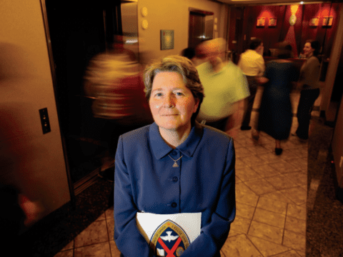 Middle-aged white woman in purple suit