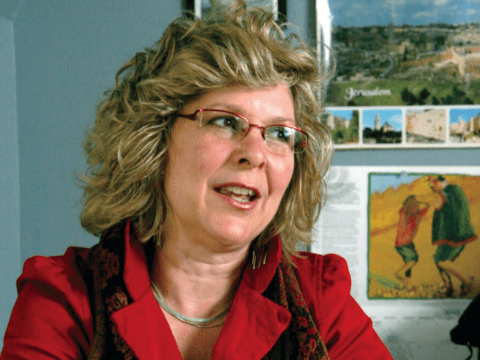 White woman with blonde hair in red shirt