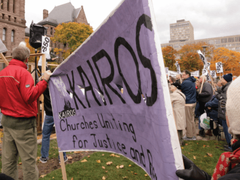 People at protest march holding signs