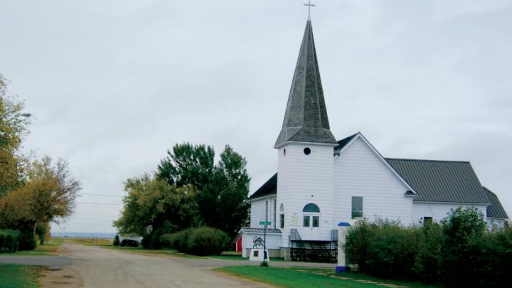 White clapboard church in rural prairie