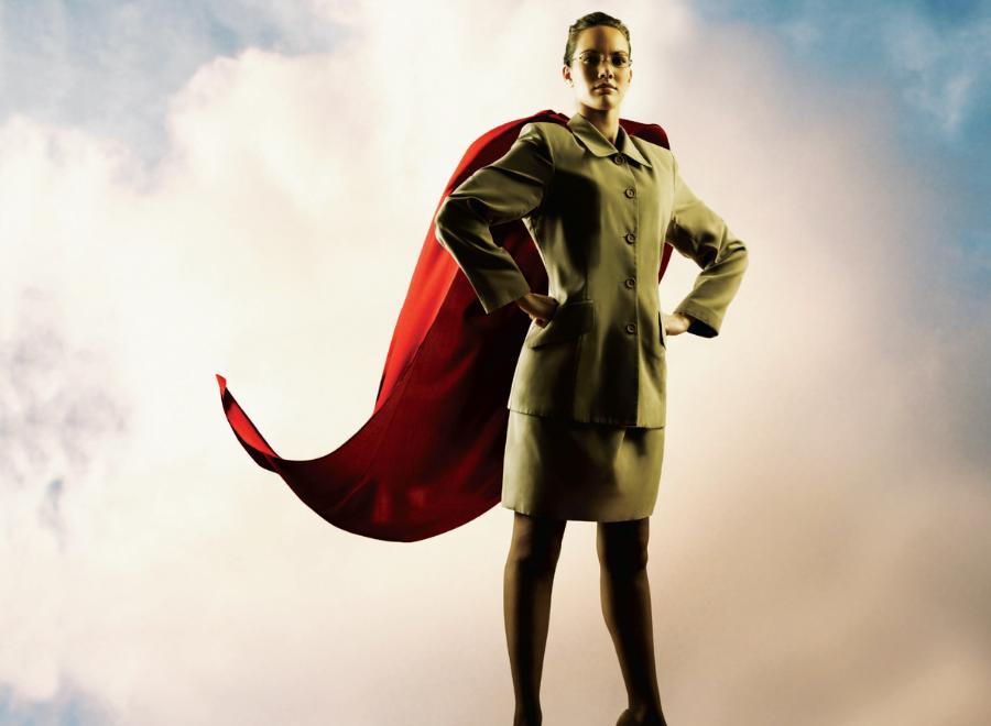 Young white woman in suit with red superhero cape