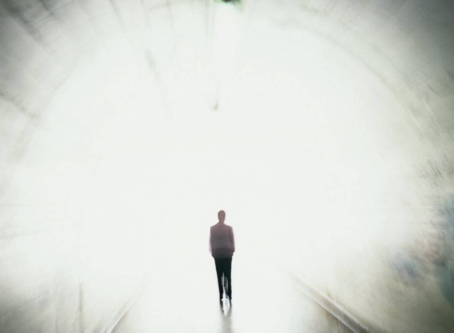 Illustration of a person walking toward a bright light