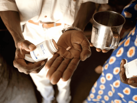 Hands of Black man and woman holding drugs
