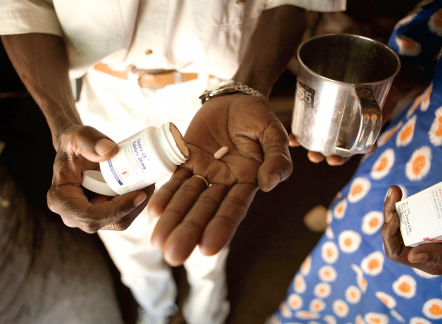 Hands of Black man and woman holding drugs