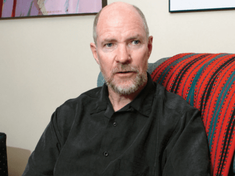 Bearded white man sitting on chair