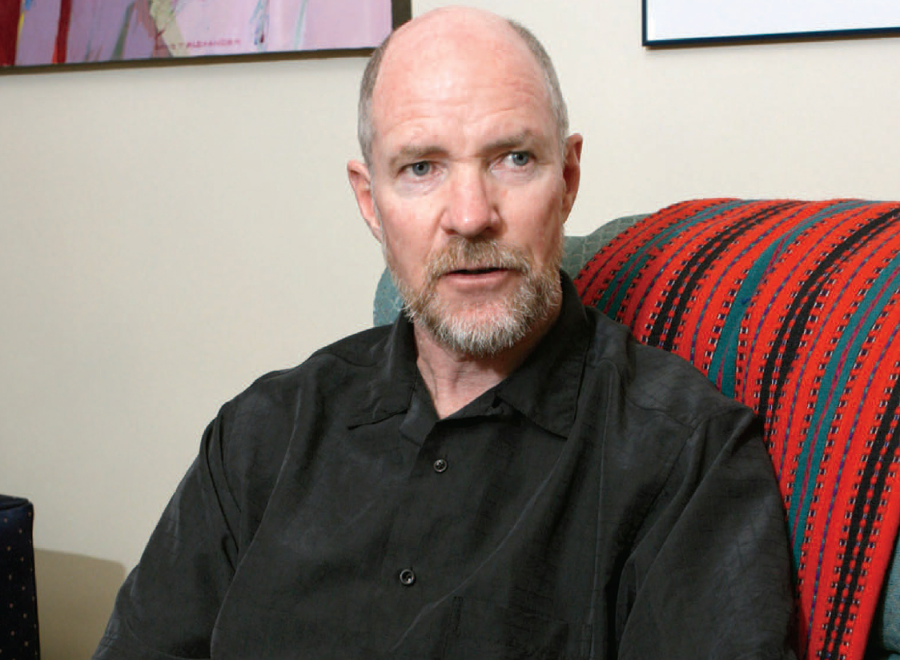 Bearded white man sitting on chair