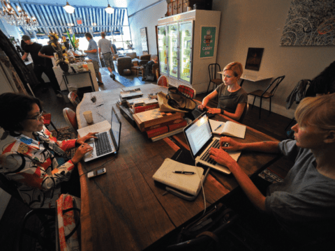 People working at computers in a cafe