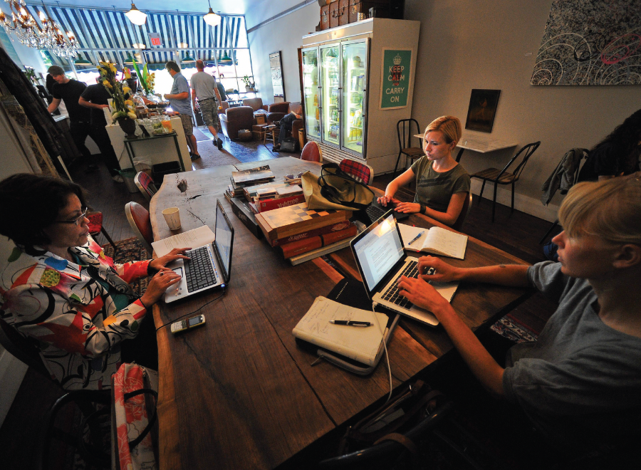 People working at computers in a cafe