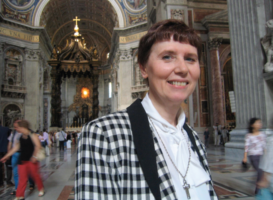 White woman in church smiling at camera