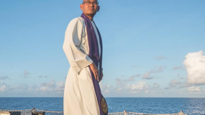 main in religious garb on ship deck
