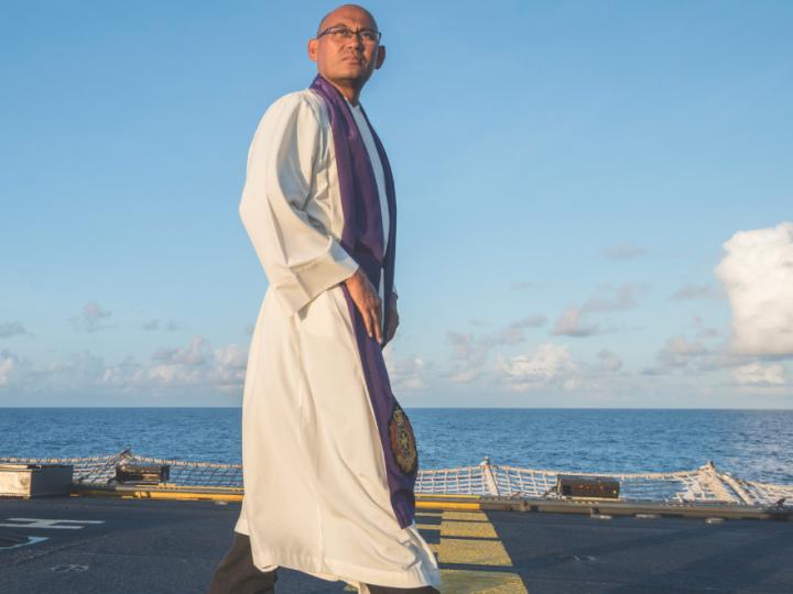 main in religious garb on ship deck