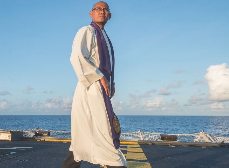 main in religious garb on ship deck