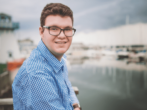 young man in dark glasses on waterfront