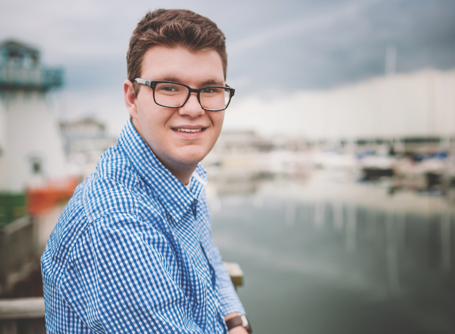young man in dark glasses on waterfront