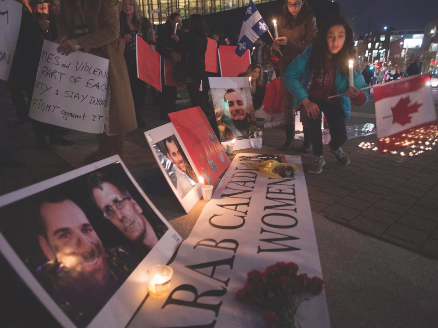 nighttime vigil with signs