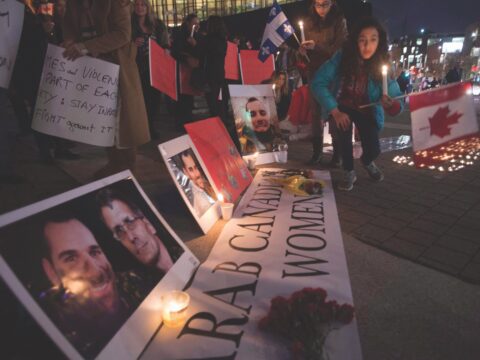 nighttime vigil with signs