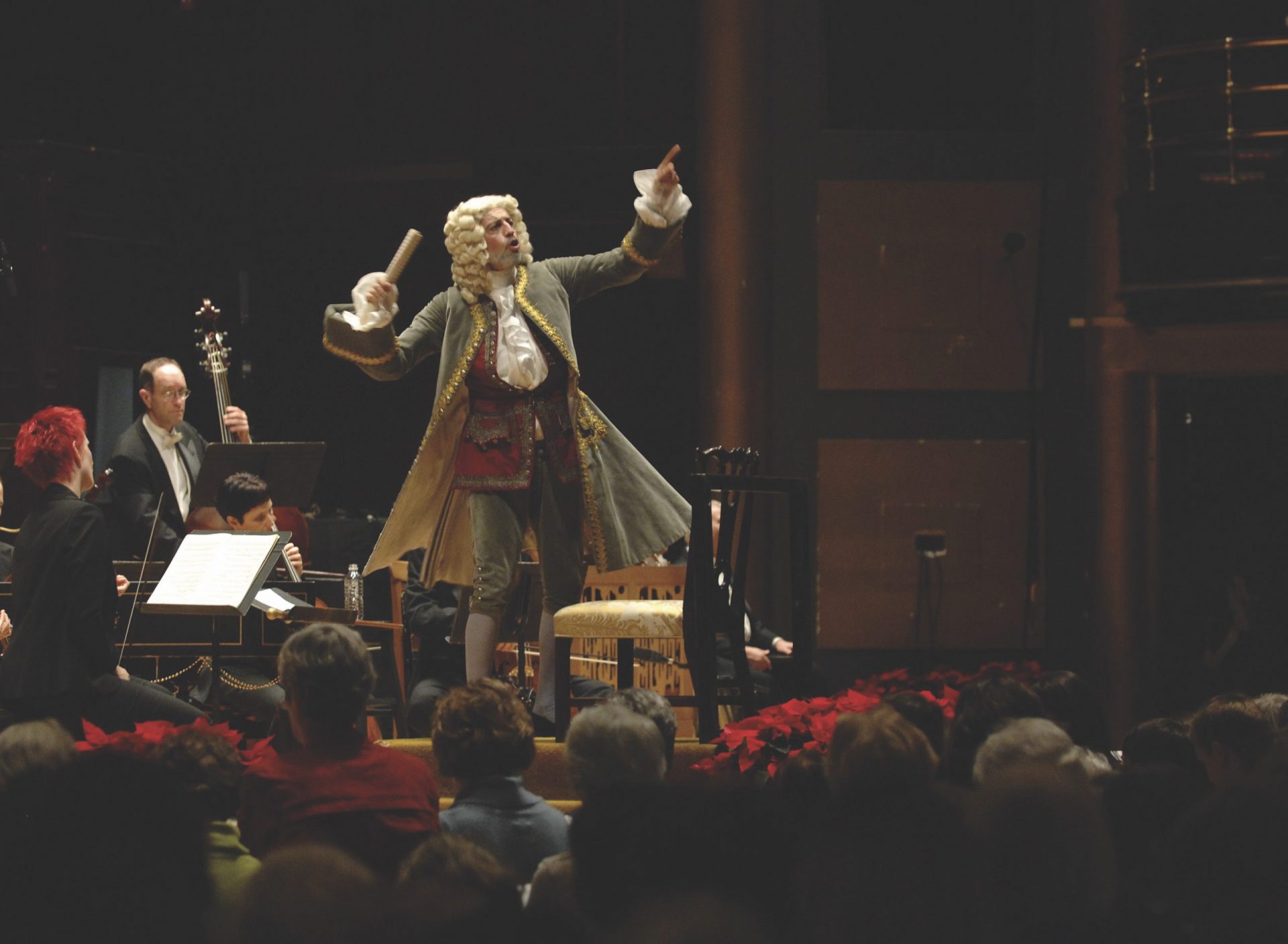 man dressed as Handel conducts