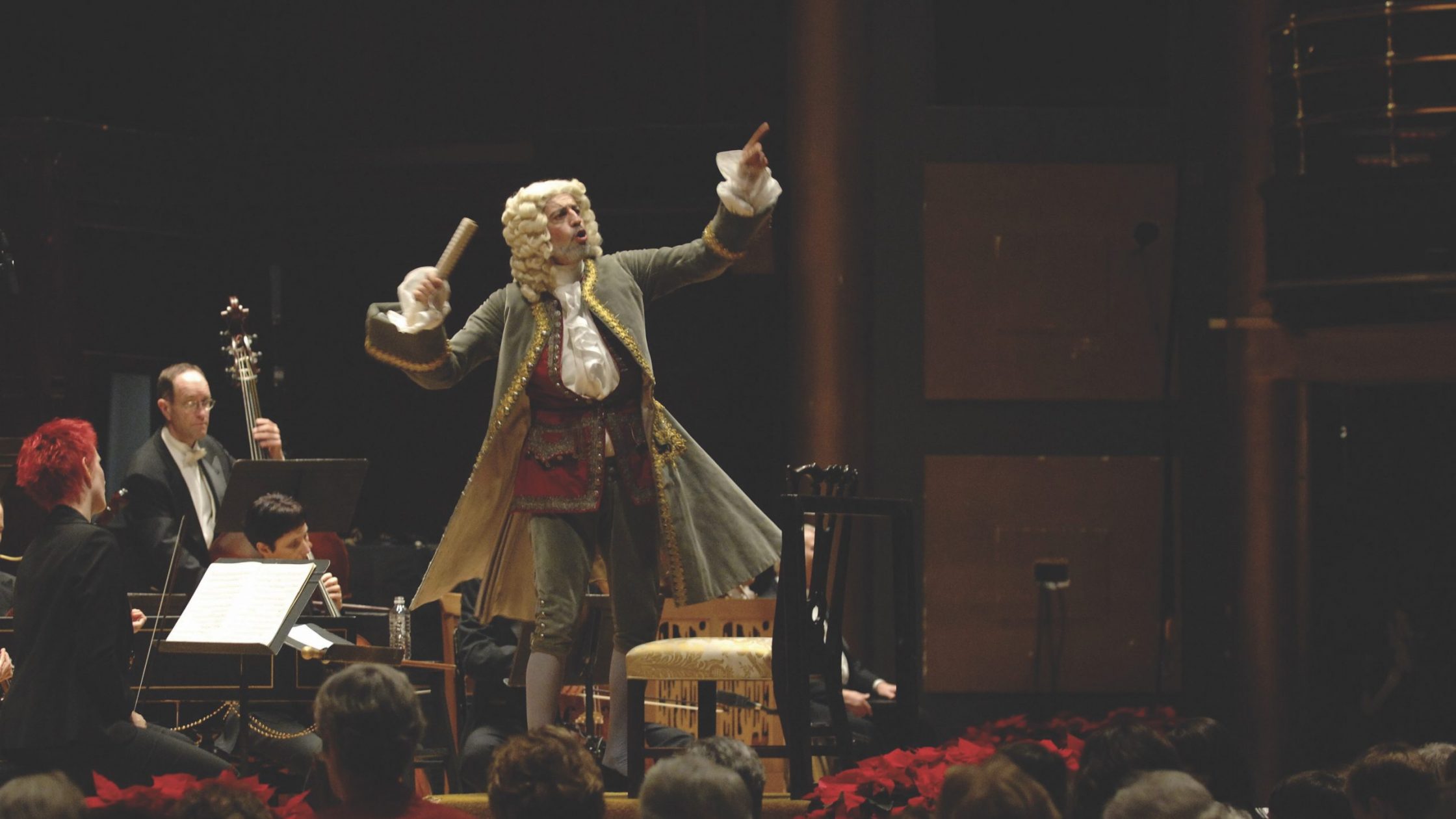man dressed as Handel conducts