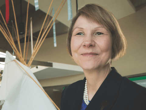 woman standing in front of a teepee