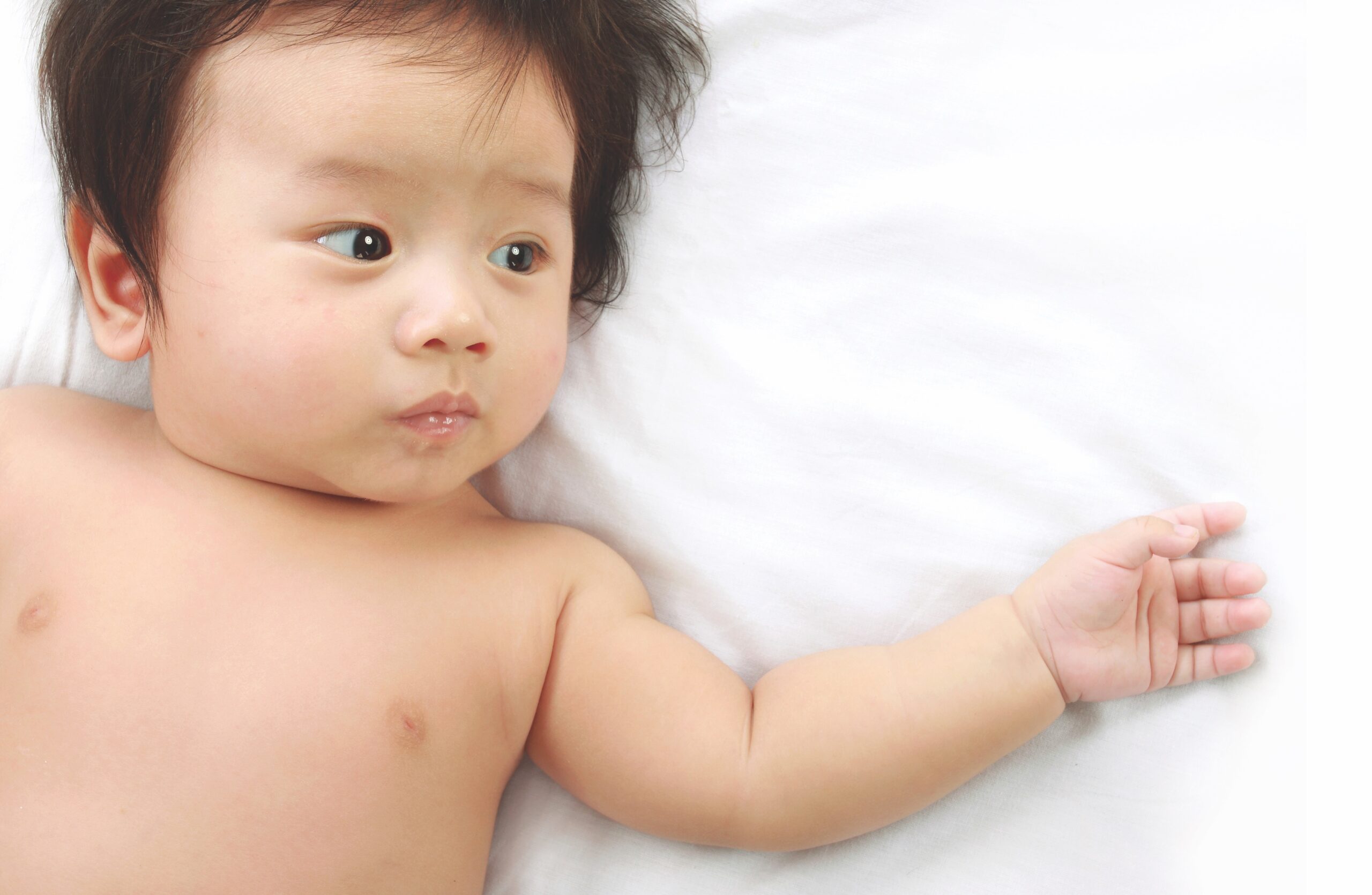 Baby lying on sheet