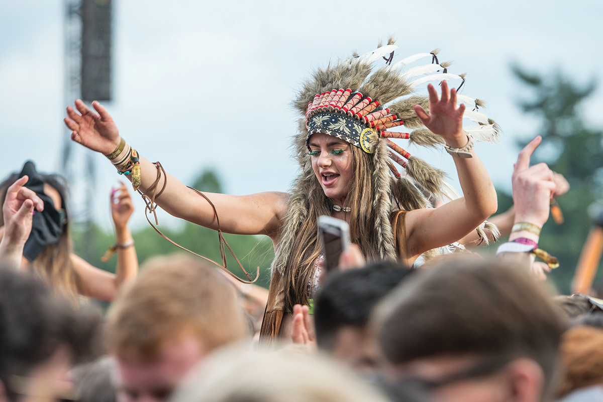 A music festival reveller in 2015. Several music festivals have now banned headdresses. Photo by Ollie Millington/WireImage/Getty Images
