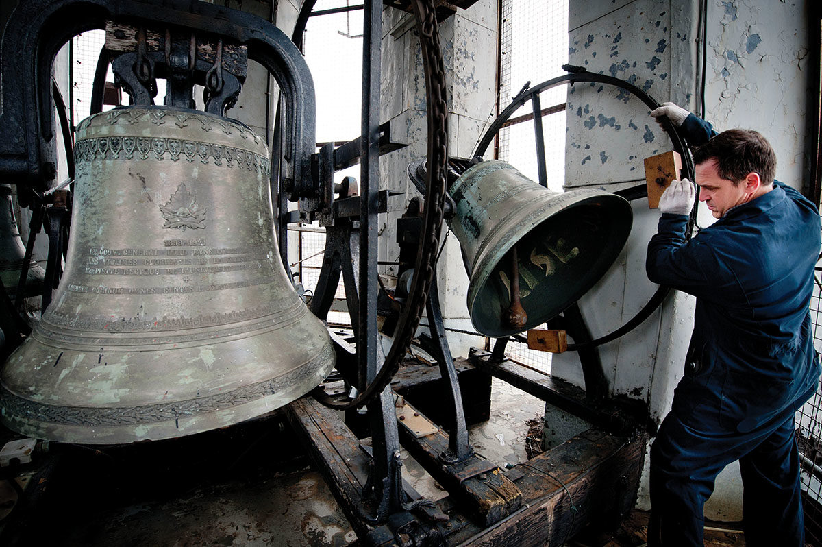 Bell repairer Daniel Désormiers examines the clapper on one of the bells at Notre-Dame-des-Sept-Douleurs in Montreal in 2011. Photo by Peter McCabe