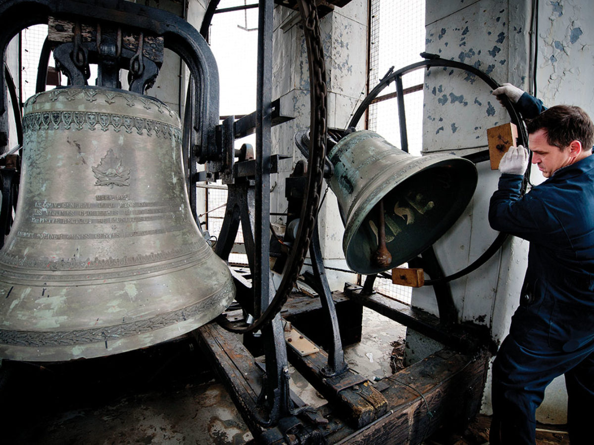 Bell repairer Daniel Désormiers examines the clapper on one of the bells at Notre-Dame-des-Sept-Douleurs in Montreal in 2011. Photo by Peter McCabe