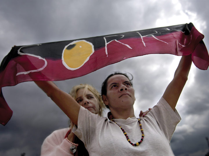 Rhonda Randall (left) and Sharon Mumbler stand proud with their “sorry” scarf as Australia’s prime minister delivers an apology to Indigenous peoples of Australia in 2008. Photo by David Hill/Newspix/Getty Images