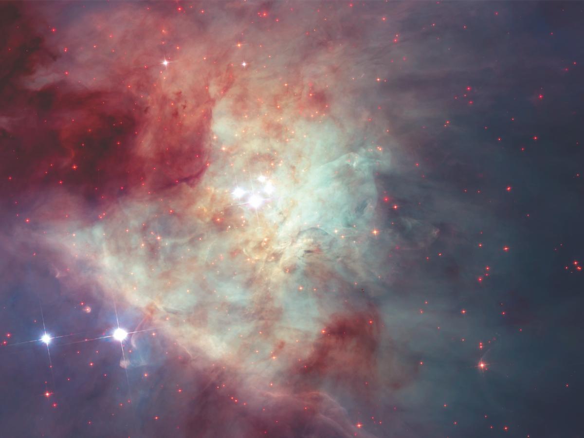 A grouping of young stars, called the Trapezium Cluster (centre), shines from the heart of the Orion Nebula in this photo by NASA’s Hubble Space Telescope. Photo: NASA/ESA