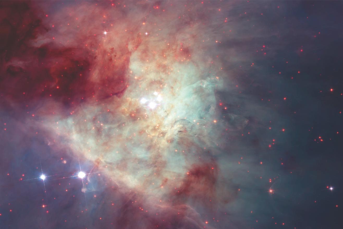 A grouping of young stars, called the Trapezium Cluster (centre), shines from the heart of the Orion Nebula in this photo by NASA’s Hubble Space Telescope. Photo: NASA/ESA