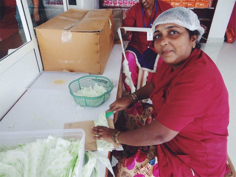 A woman makes sanitary pads at the Myna Mahila Foundations's factory in Mumbai, India.